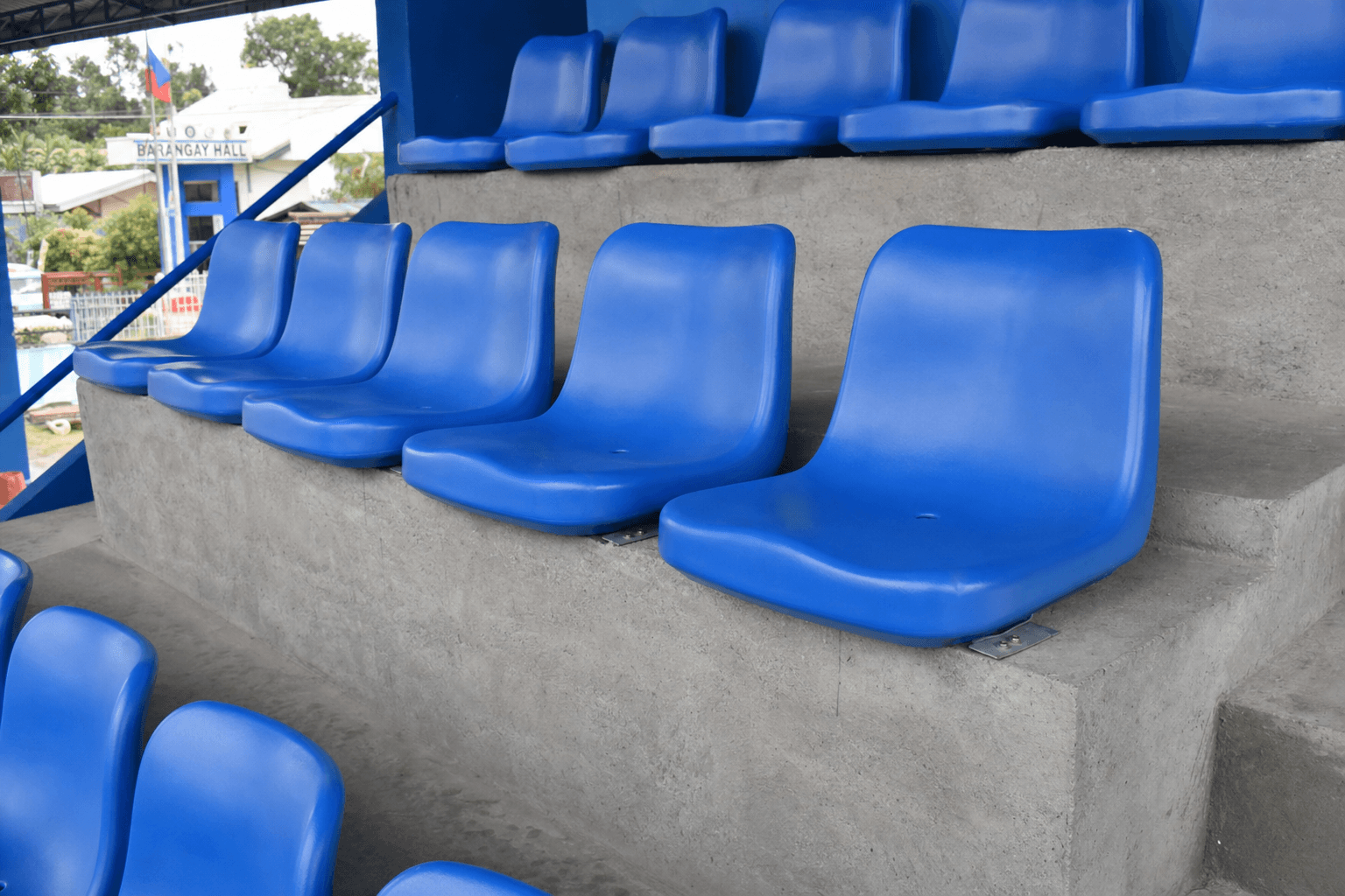 Modern stadium seats under bright sunlight